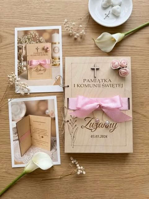 First Holy Communion invitation set with wooden cards, pink roses, cross symbol, white calla lilies, and pearl beads on wooden surface